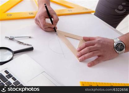 Male engineer working on drawings and blueprints