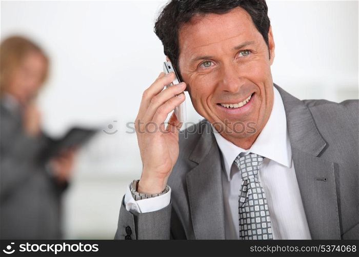 Male executive using cellphone