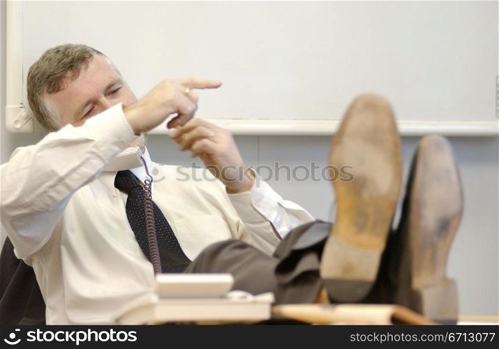 male executive with feet on desk