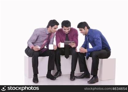 Male executives looking at a message on a mobile phone
