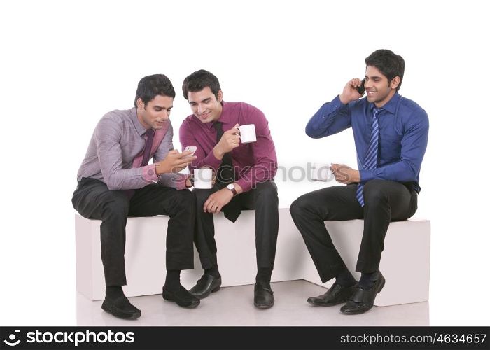 Male executives looking at a message on a mobile phone