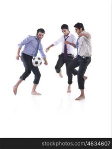 Male executives playing soccer