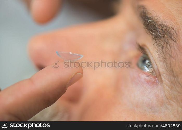 male eye with contact lens close up
