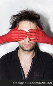 male face with eyes closed women&rsquo;s red hands