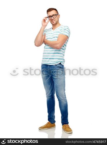 male, fashion and people concept - smiling young man in eyeglasses over white