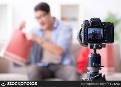 Male fashion blogger recording video for vlog