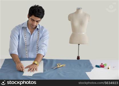 Male fashion designer working in fashion studio