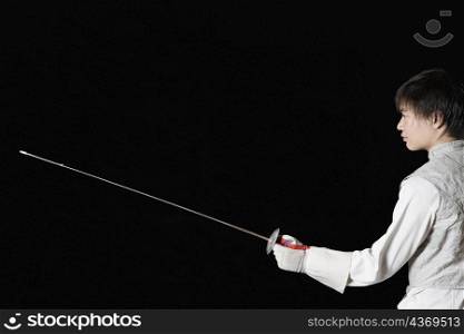 Male fencer holding a fencing foil