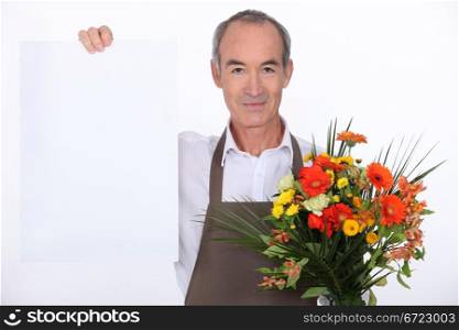 Male florist holding message board