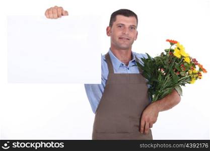 Male florist with bunch of flowers