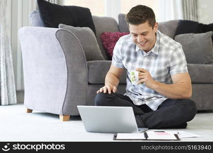 Male Freelance Worker Using Laptop At Home