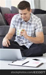 Male Freelance Worker Using Laptop At Home