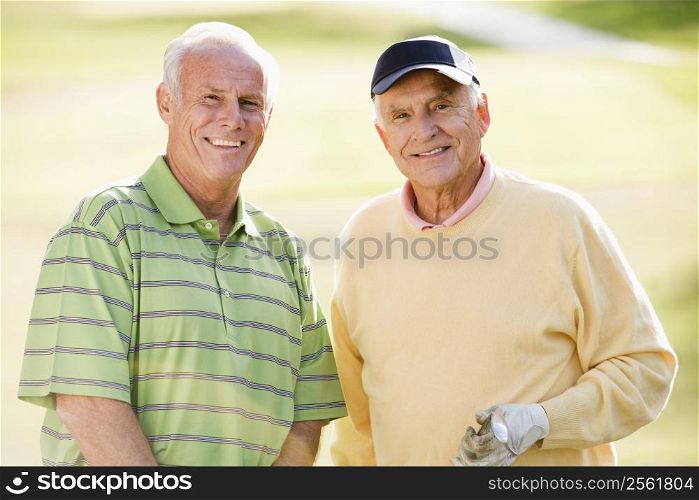 Male Friends Enjoying A Game Of Golf