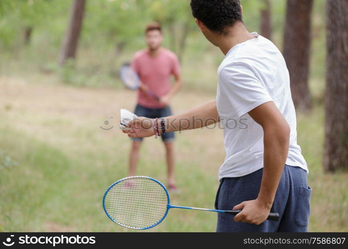 male friends playing recreational badminton