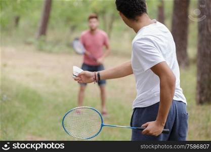 male friends playing recreational badminton
