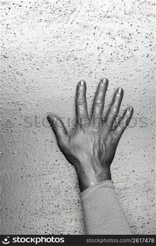 male futuristic man silver hand over textured steel background
