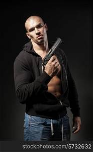 male gangster holding a gun isolated on dark background