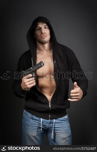 male gangster holding a gun isolated on gray background