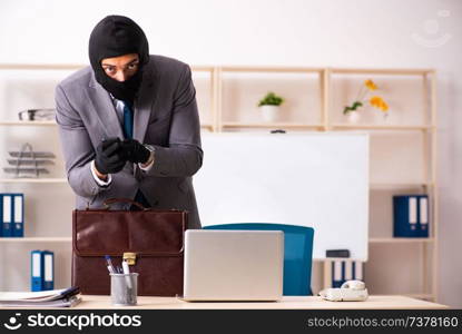 Male gangster stealing information from the office 