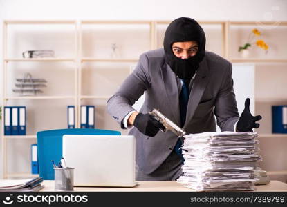 Male gangster stealing information from the office 