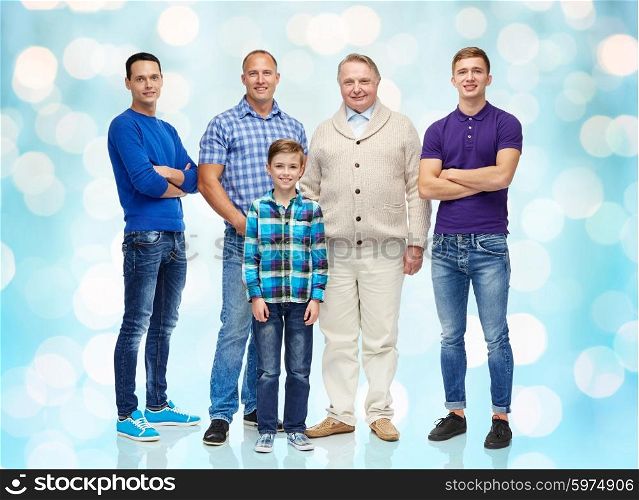male, gender, generation and people concept - group of smiling men and boy over blue holidays lights background