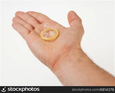 Male giving a condom on a white background