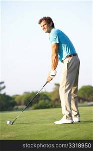 Male Golfer Teeing Off On Golf Course