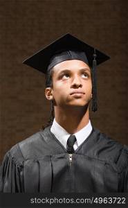 Male graduate looking up