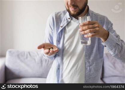 male grey will pills glass water. High resolution photo. male grey will pills glass water. High quality photo