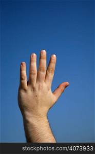 male hand and the blue sky as background