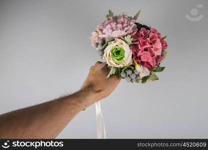 male hand giving wedding bouquet. male hand giving wedding bouquet, first-person view