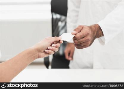 male hand giving white card