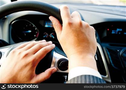male hand holding a car wheel