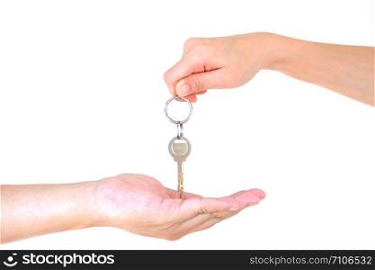 Male hand holding a key and handing it over to another person isolated