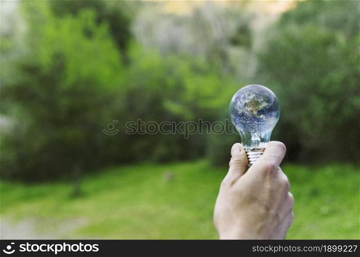 male hand holding earth glass bulb. Resolution and high quality beautiful photo. male hand holding earth glass bulb. High quality beautiful photo concept
