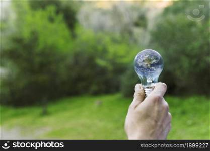 male hand holding earth glass bulb. Resolution and high quality beautiful photo. male hand holding earth glass bulb. High quality beautiful photo concept