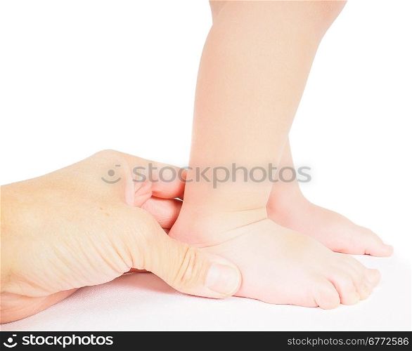 Male hand holding firmly around a foot of toddler isolated on white