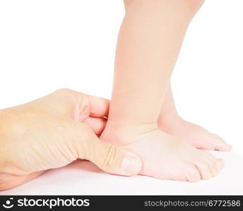 Male hand holding firmly around a foot of toddler isolated on white