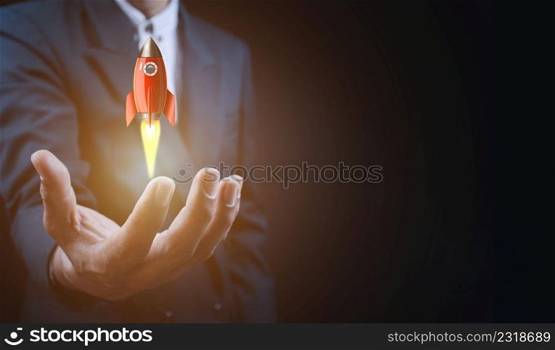 Male hand holding rocket icon that takes off, rocket is launching and flying out, Business start up, Icon marketing on modern virtual interface.Start up concept