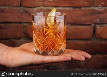 Male hand holds glass of whiskey