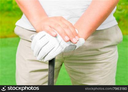 male hand in a glove with golf club close-up