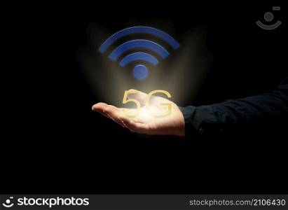 male hand on a black background and high-speed internet icon 5. Introduction of new modern technologies