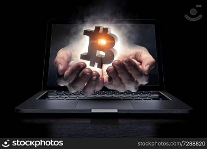 Male hand out of laptop screen presenting bitcoin concept. 3D rendering. Crypto currency concept. Mixed media