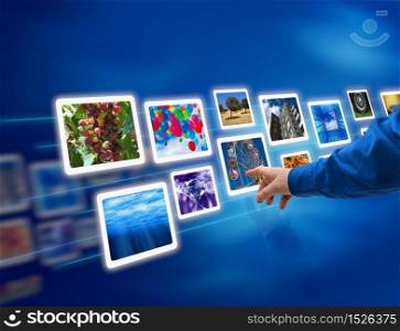 Male hand selecting images multimedia information flow. Hand select images flow