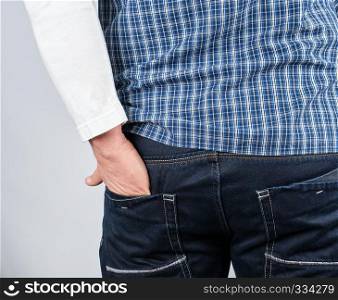 male hand shoved into the back jeans pocket on a white background