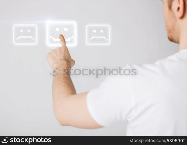 male hand touching virtual screen with smile button