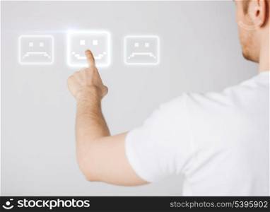 male hand touching virtual screen with smile button