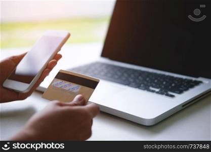 Male hand using credit card with laptop pc, Online shopping and payment concept.