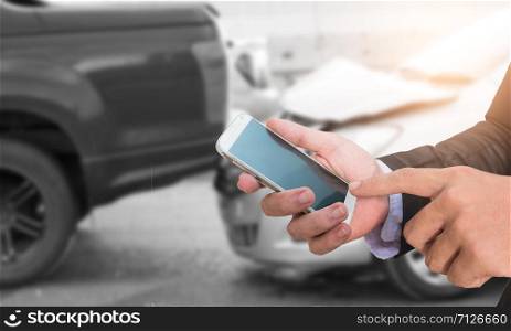 Male hand using smart phone and call the car insurance.