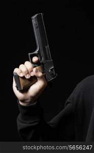 male hand with gun isolated on black background